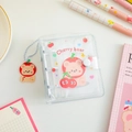 Detail of transparent PVC 3-hole mini binder featuring cartoon bear and matching keychain - White Cherry Bear