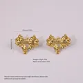 Golden stainless steel bow stud earrings featuring unique irregular folded texture details - Stainless Steel Pleated Bow Studs