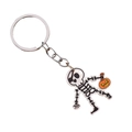 Halloween keychain featuring a cartoon skull holding a pumpkin with metal ring - Skeleton Figure