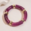 Detail of purple marble resin tube bracelet with gold cylindrical metal spacer beads - Purple