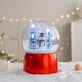 22cm Christmas snow globe featuring a snowman and glowing trees on a red base - Snowing Globe Snowman (Height 22cm)