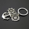Macro view of vintage silver nautical keychain with anchor, rudder, and compass charms - Anchor Helm Compass