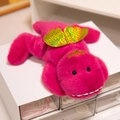 Soft rose red plush dinosaur doll with golden laser heart wings in a lying pose - Dinosaur