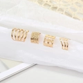 Σετ από τέσσερα χρυσά ear cuffs με κενά αστέρια και μινιμαλιστικά σχέδια με κύματα - Χρυσό