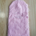 Pink knitted balaclava mask with fuzzy long plush texture on wooden floor background - One Size / Pink