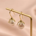 Baroque freshwater pearl earrings with gold frames on a professional display stand - Gold Hook White Pearl