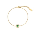 Golden heart bracelet with green gemstone and sparkling zircons on white background - Heart Bracelet / Gold (Green Stone)