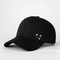 Detailansicht der schwarzen Baumwollkappe mit weißem X-Augen-Zungen-Stickereidesign - Schwarz