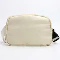 Off-white nylon sports belt bag with adjustable white strap and durable black plastic buckle - Ivory