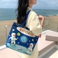 Navy blue canvas tote bag featuring astronaut universe print and sturdy handles - Space Walk
