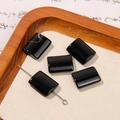 Macro detail of polished black agate rectangular beads on a wooden tray for DIY jewelry - Black Rectangular Agate Style (2号)