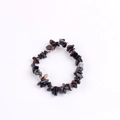 Natural black obsidian stone chip bracelet with rustic textures on a white background - Black Agate