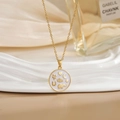 Golden necklace with circular heart and moon enamel pendant on soft fabric background - Round White Heart Elephant Moon Style (XL0465)