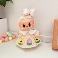 Labubu doll wearing a cream white dress with flower embroidery and matching bow accessory - Milk Apricot Flower Dress Set / First And Second Generation Keychains Are Compatible With La Cloth Dolls. Dolls Not Included.