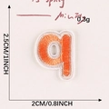 Orange embroidered lowercase letter q patch with white border for fabric decoration - Letter-Q