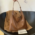 Brown leather large capacity hobo bag styled with aesthetic blazer and book - Brown