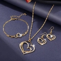 Detail of gold jewelry set with hollow heart-shaped pendants and micro-pave diamonds - Double Heart Necklace Earrings Bracelet / Gold