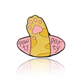 Cartoon enamel pin featuring a yellow cat paw with pink pads and a Saturn-like ring - Pink Pawty Party
