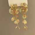 Detail showing golden flower dangle earrings with shiny rhinestones and textured petals - 12# Hollow Flower