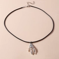 Macro shot of silver skeleton hand pendant on black cord with adjustable metal chain - Skeleton Claw Necklace