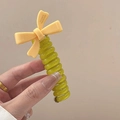 Green spiral hair tie with a yellow resin bow featuring France Handmade lettering - Yellow [Candy Bow]