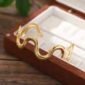 Bracciale rigido a onda in acciaio inossidabile oro 18K da donna su portagioie in legno - Oro