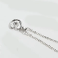 Detailed view of silver U-shaped horseshoe pendant with circular scale texture pattern - Letter C / Silver