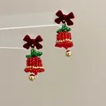Close-up of handmade beaded Christmas bell earrings with a red velvet bow detail - Flocked Bow Bell / Earring Hooks