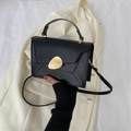 Chic black crossbody bag with gold pebble buckle and minimalist geometric fold design - Black
