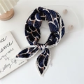 Pleated navy blue square silk scarf with orange fan patterns tied in a knot - White Border Blue Fan Pattern