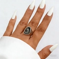 Detail of a geometric dark grey acrylic stone ring on a model with white manicured nails - Silver Avant-Garde Large Stone Ring (03)