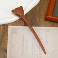 Detailed view of hand-carved bear topping on sandalwood hair stick over vintage letters - Little Bear Carved Style (F2023665)