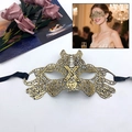 Elegant gold lace masquerade mask with intricate cutouts and black satin ribbons - Tiger