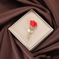 Elegant gold rose brooch with red petals and pearl on brown satin background - Rose / Red