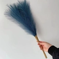 Hand holding 55cm bundle of fluffy dark blue artificial pampas grass for boho decor - 53-55cm / Cyan