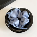 Blue satin scrunchie with delicate bow details on a polished black display tray - Royal Blue