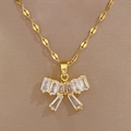 Primo piano ciondolo a fiocco dorato con zirconi su catena piatta a maglie - F218 Collana (Catena in Acciaio al Titanio Ciondolo in Rame)