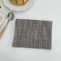 Detailed texture of gray cotton linen placemat with white vertical stripes on marble surface - Dark Gray