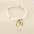 Close-up of pearl bead bracelet featuring a purple zircon grape pendant and gold clasp - Zirconia Purple Grape Style (KB203073-Z)