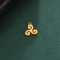 Macro shot of a golden triskele pendant with polished stainless steel finish on a dark texture - Triskele Swirl Style / Gold