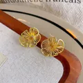 Golden ginkgo leaf shaped earrings with intricate hollow radiating lines design - E6757 Gold Hollow Crinkled Flower