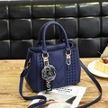 Dunkelblaue Handtasche aus genarbtem Leder mit Bommel-Anhänger und Schultergurt - Königsblau