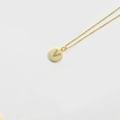 Minimalist gold necklace with a round pendant featuring a zircon V initial on white background - Letter V
