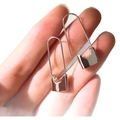 Minimalist silver paperclip earrings with polished square clasp shown held by hand - U-Shape Lock / Silver