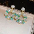 Vintage gold hoop earrings featuring white pearls and colorful crystals on jewelry box - Gold Palace Flower