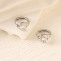 Macro shot of silver heart-shaped zircon earrings with detailed pave stones on silk background - Silver (Heart Zircon)