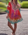 Detail of bohemian floral print on V-neck loose tunic blouse worn in outdoor setting - XXL / Red