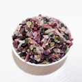Mixed natural tourmaline crystal chips in a white bowl with colorful mineral tones - Mixed Tourmaline
