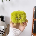 Close-up of green plush earphone case with cartoon embroidered face and hanging strap - Papaya Green Plush Monster Squinting Smile / AirPods 1/2 Gen