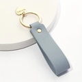 Gray leather heart keychain with golden HEHE LOVE charm on a minimalist round base - Haze Blue